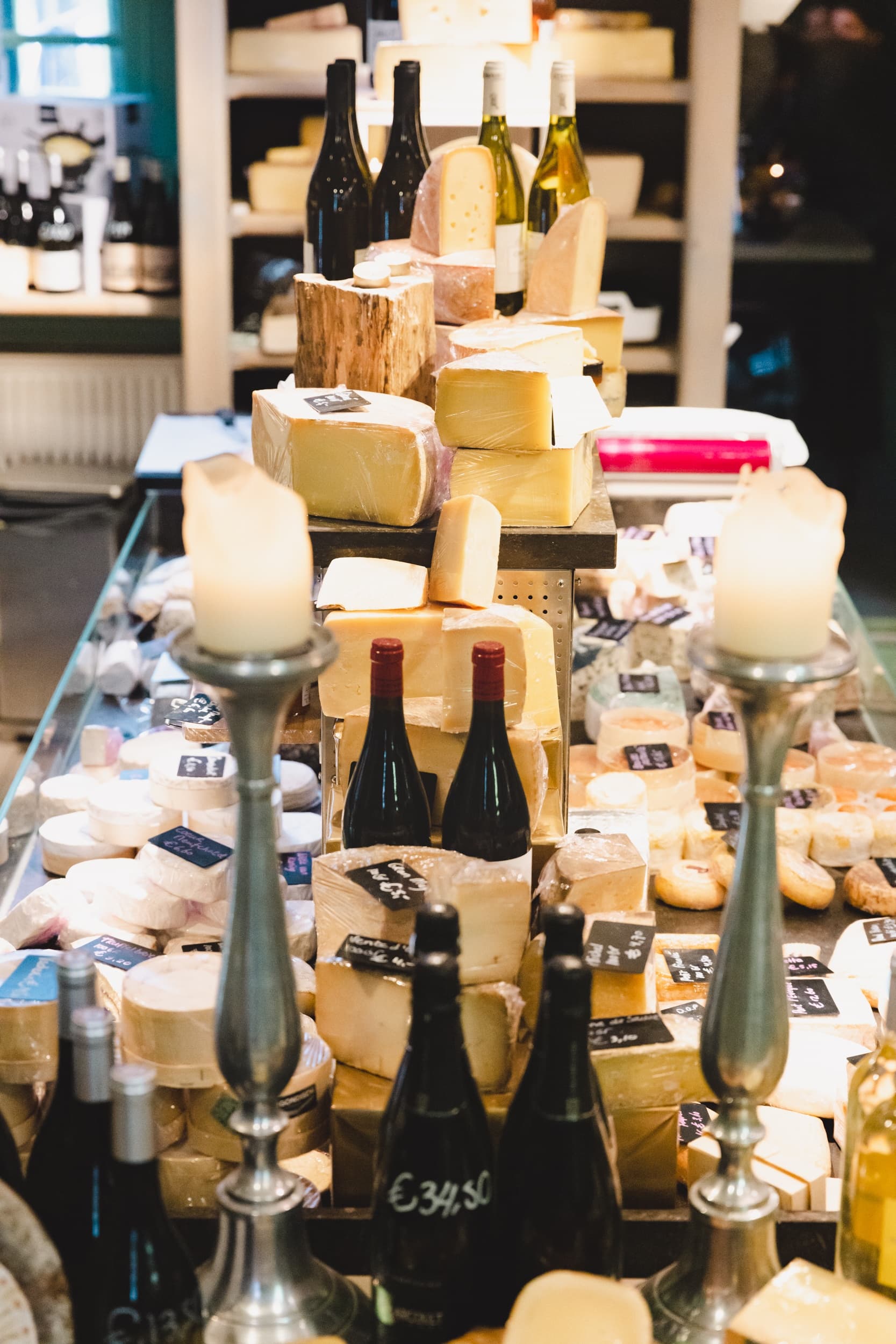 Outdoor Dutch cheese market display with cheeses and wine bottles