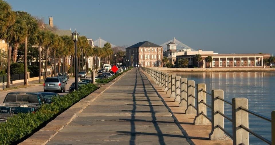 Stroll along Charleston waterfront promenade with harbor view