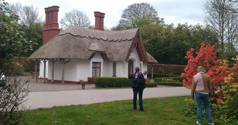 Visitors at thatched cottage garden during guided walking tour in Killarney