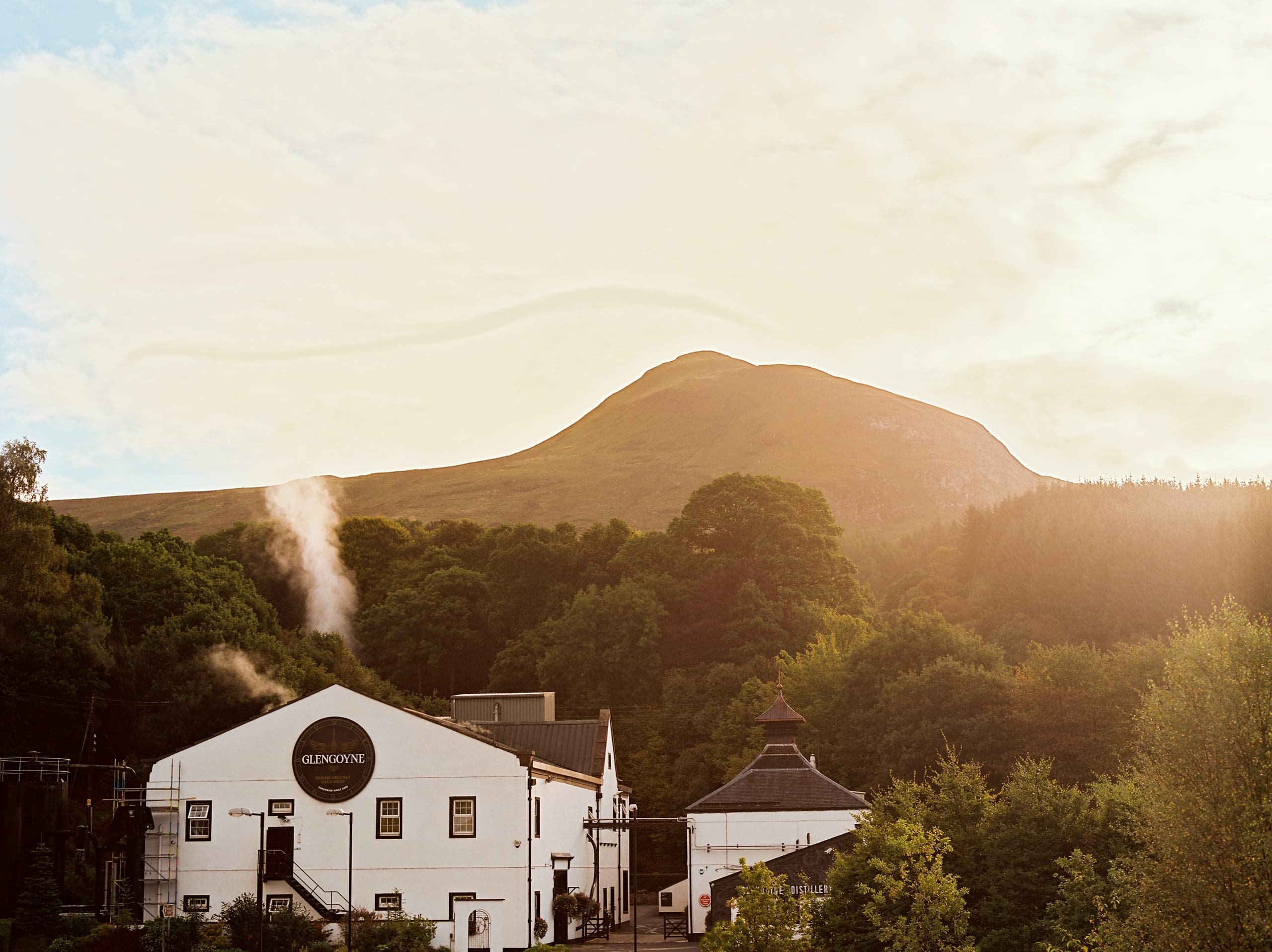 Glengoyne Distillery building in Highland glen at sunset
