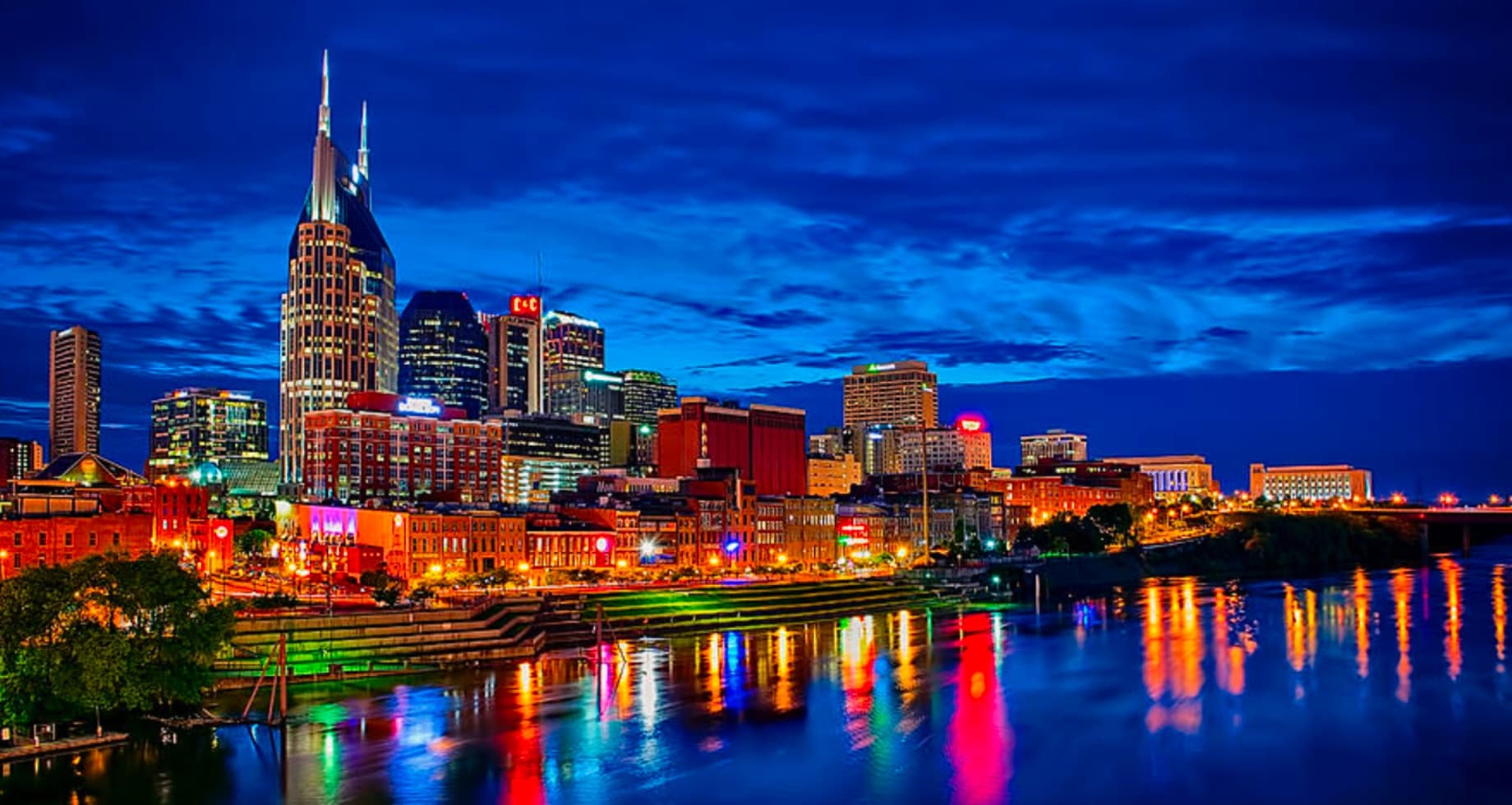 Nashville skyline at night reflecting over Cumberland Riverfront