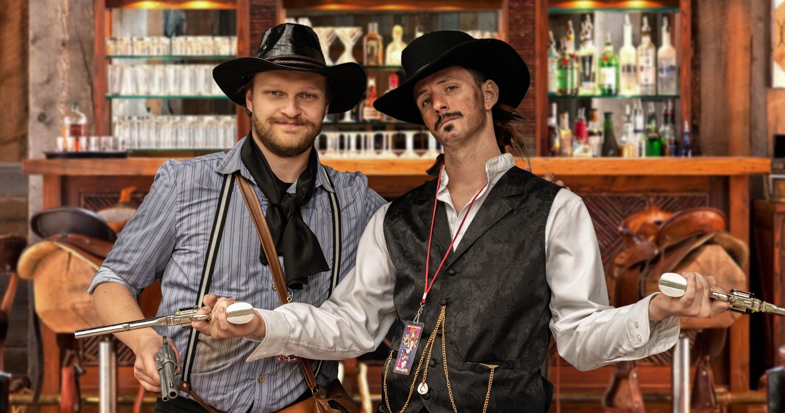 Barroom duel actors posing in rustic saloon interior, staged shoot
