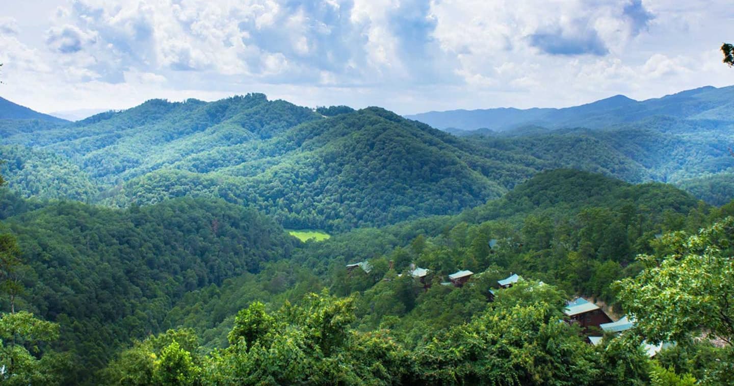 Green mountain ridges and valley seen from helicopter tour