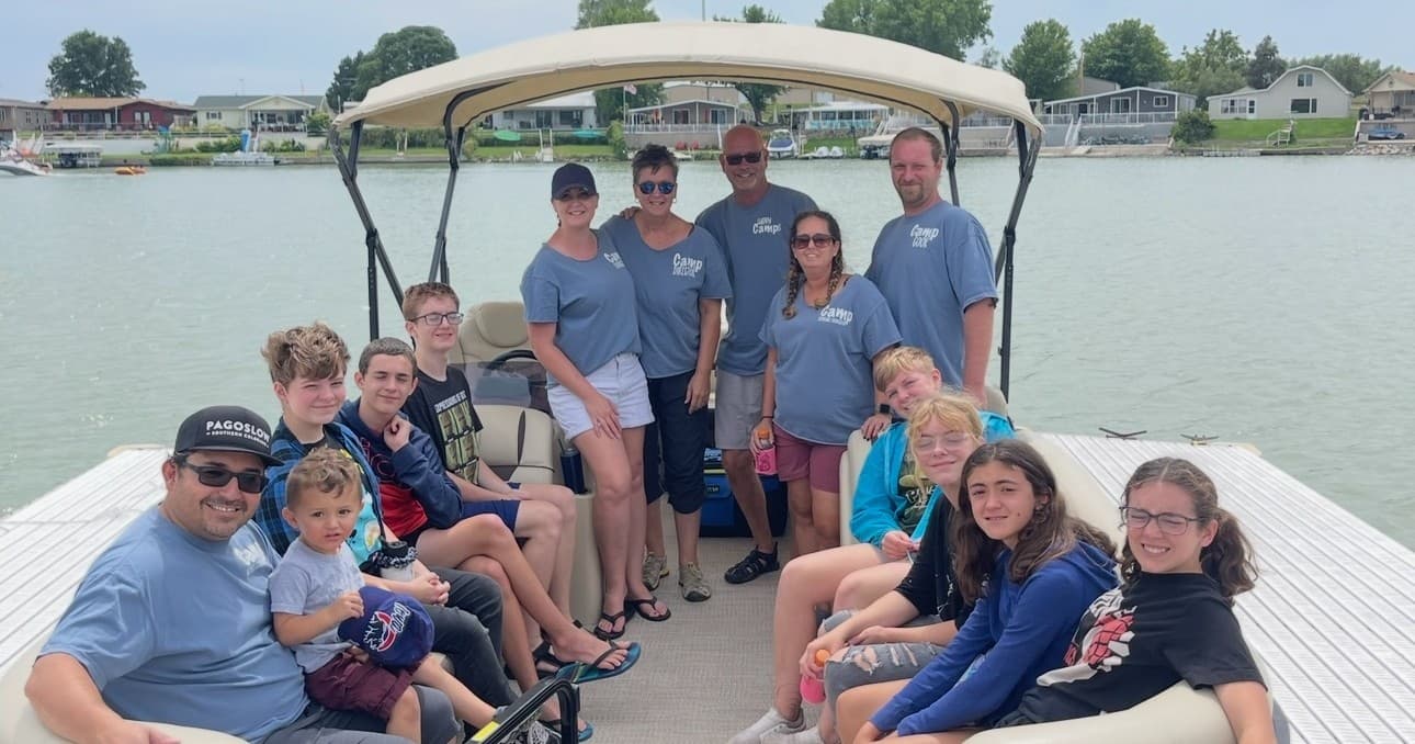 Family and friends on pontoon boat enjoying a lake cruise
