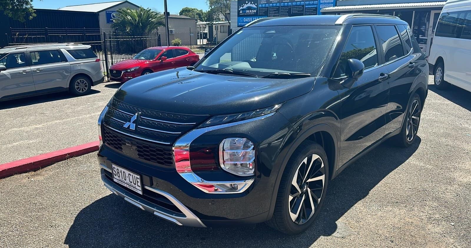 Black SUV displayed in parking lot for family road trip rental