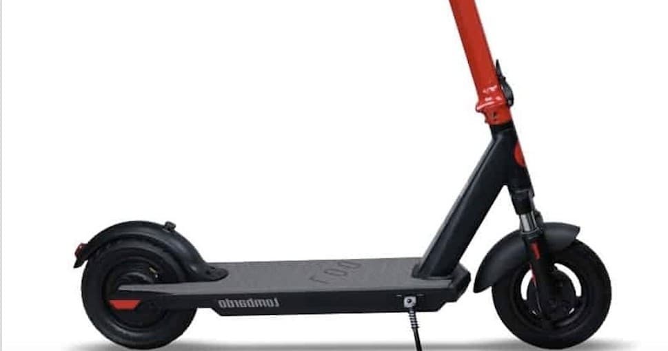 Electric scooter parked on urban waterfront boardwalk at dawn