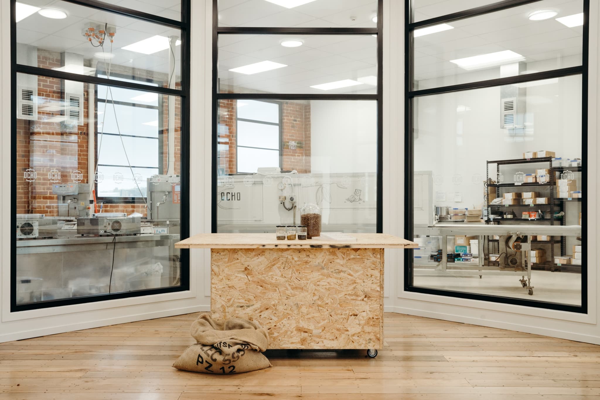 Wooden counter in modern indoor cafe roastery with glass windows, ready