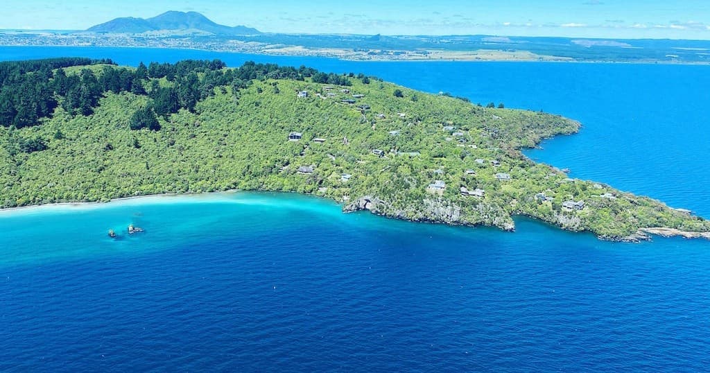 Aerial view of tropical island and turquoise bay from helicopter tour