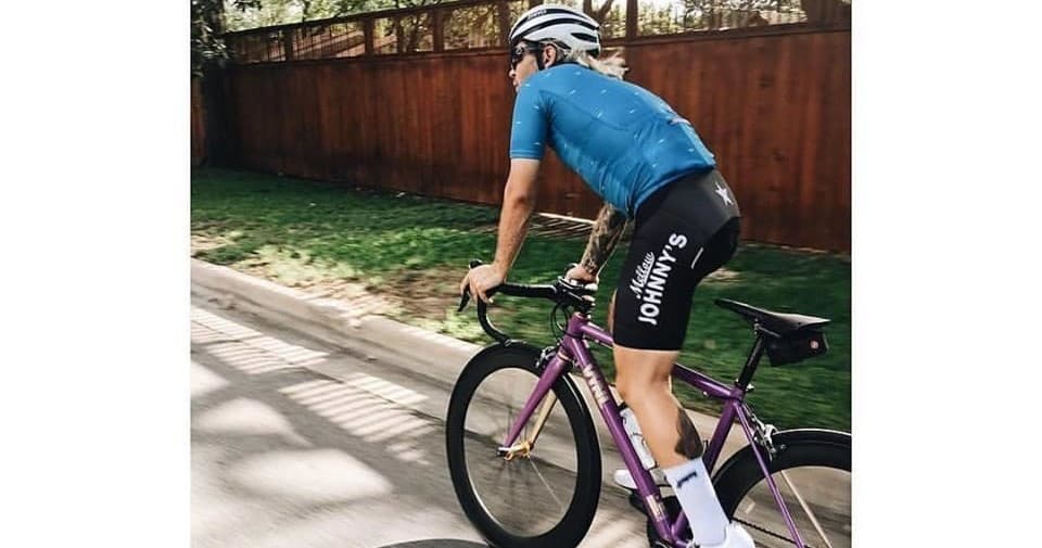 Cyclist climbing a residential road during an outdoor training ride