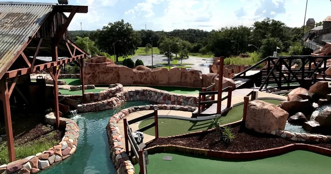Sunny miniature golf panorama showing winding water hazards