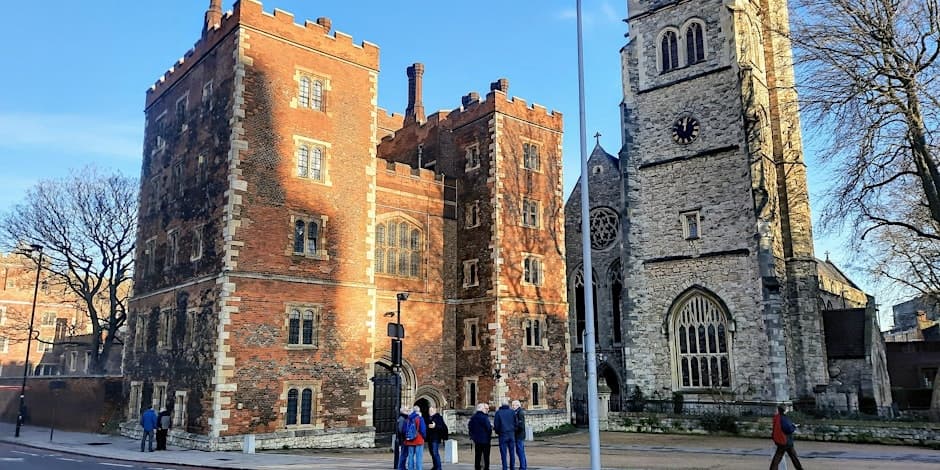 Brick Norman castle and church exterior in central London