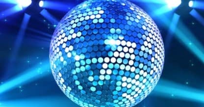 Disco ball reflecting stage lights in indoor dance club