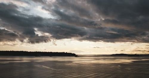 Sunset over coastal waters highlighting charter fishing experience