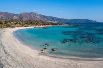 Turquoise Mediterranean bay with sandy crescent beach