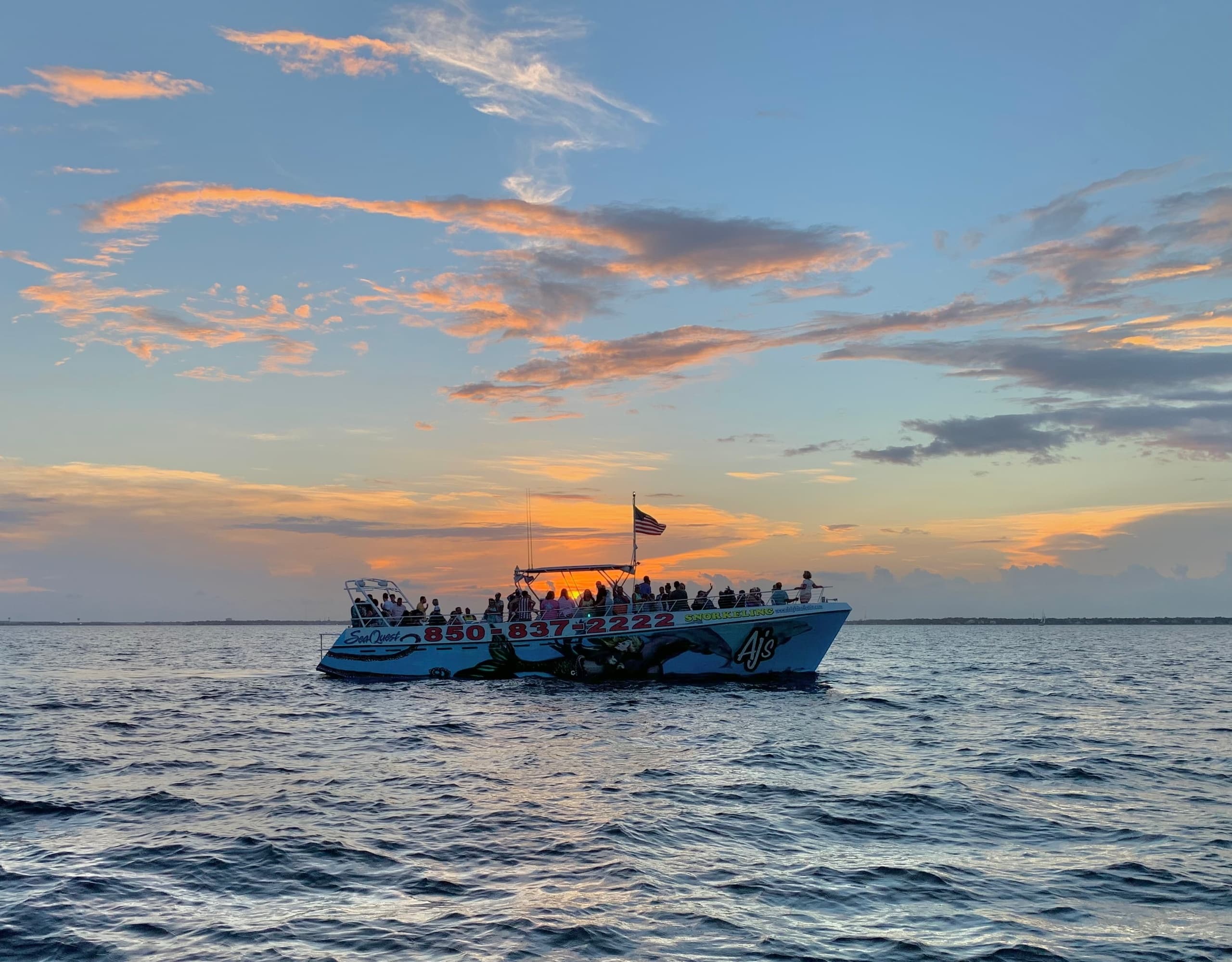 Sunset dolphin cruise boat off Destin coastline