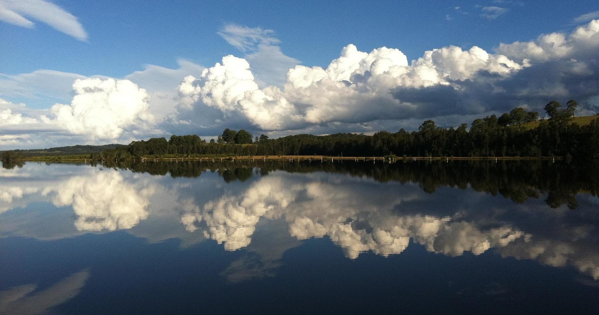Scenic lake reflection at sunrise highlighting calm waters for cruises