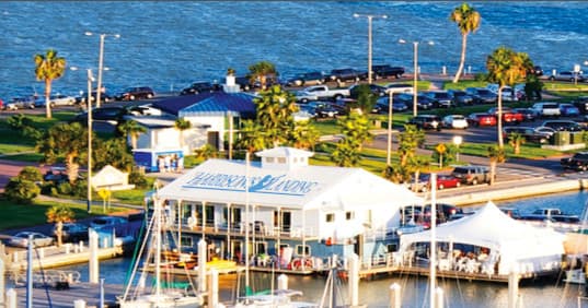Waterfront marina restaurant overlooking docks and oceanfront