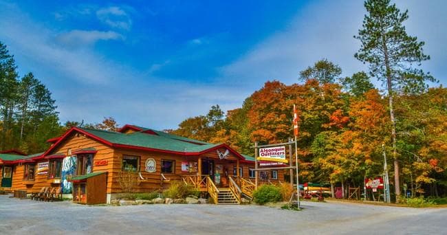 Outdoor lodge storefront with fall foliage at entrance