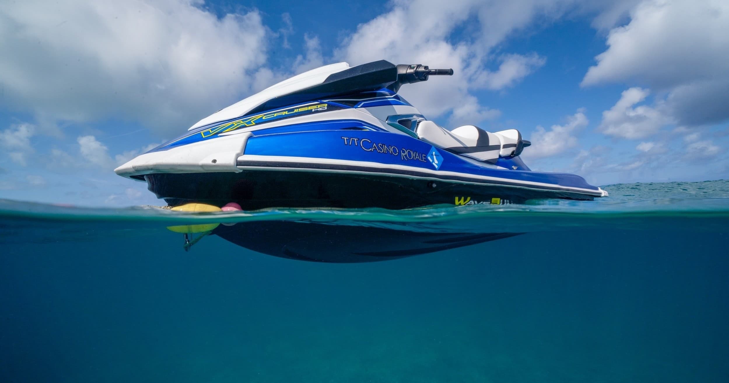 Blue jet ski over clear tropical water with underwater view