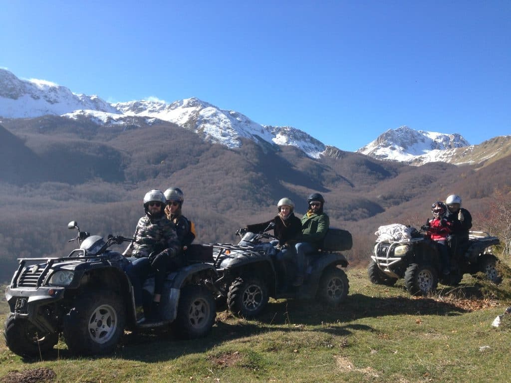 ATV riders touring snow-capped mountain trails