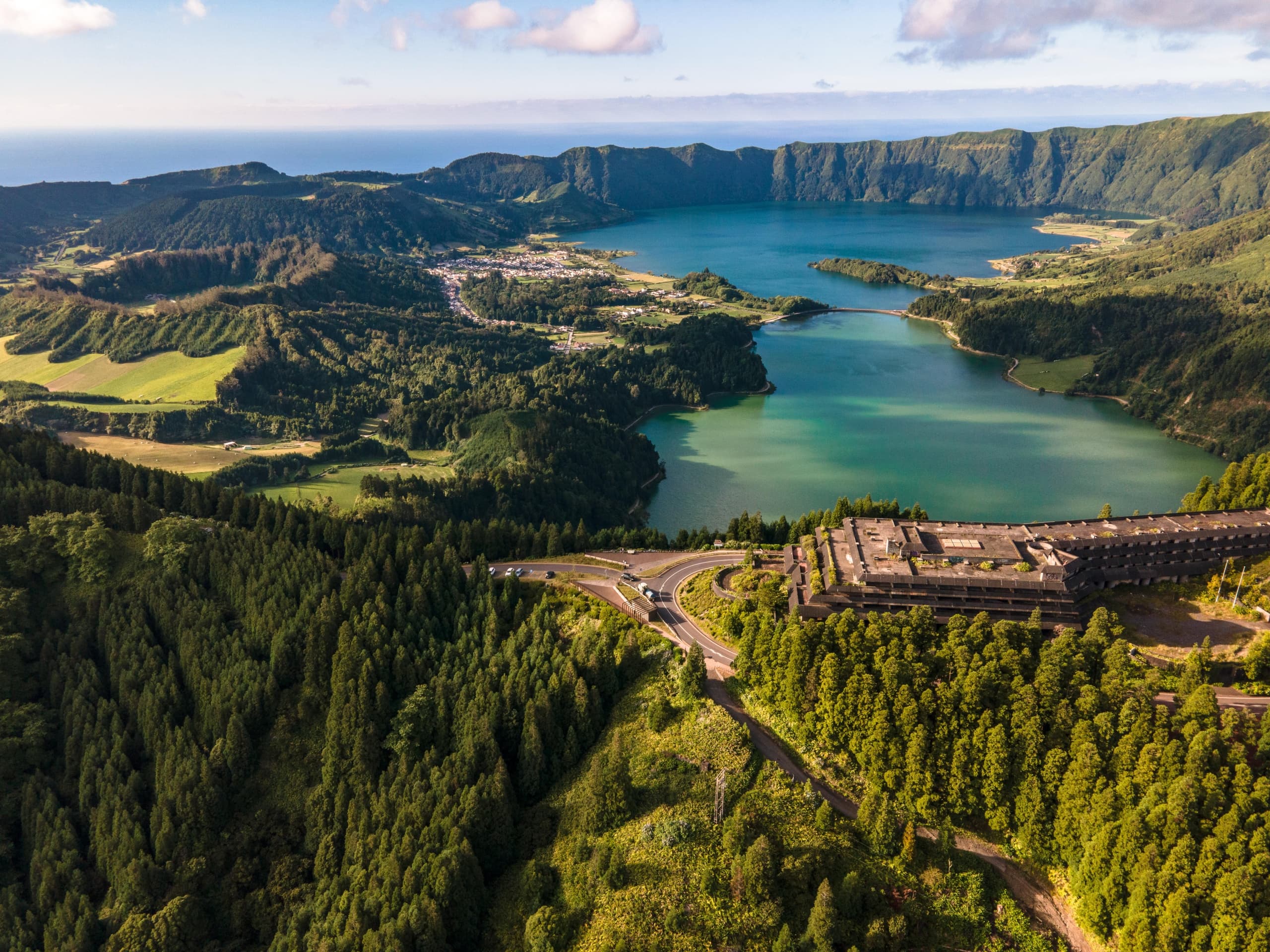 Aerial view of emerald crater lakes and forest rim