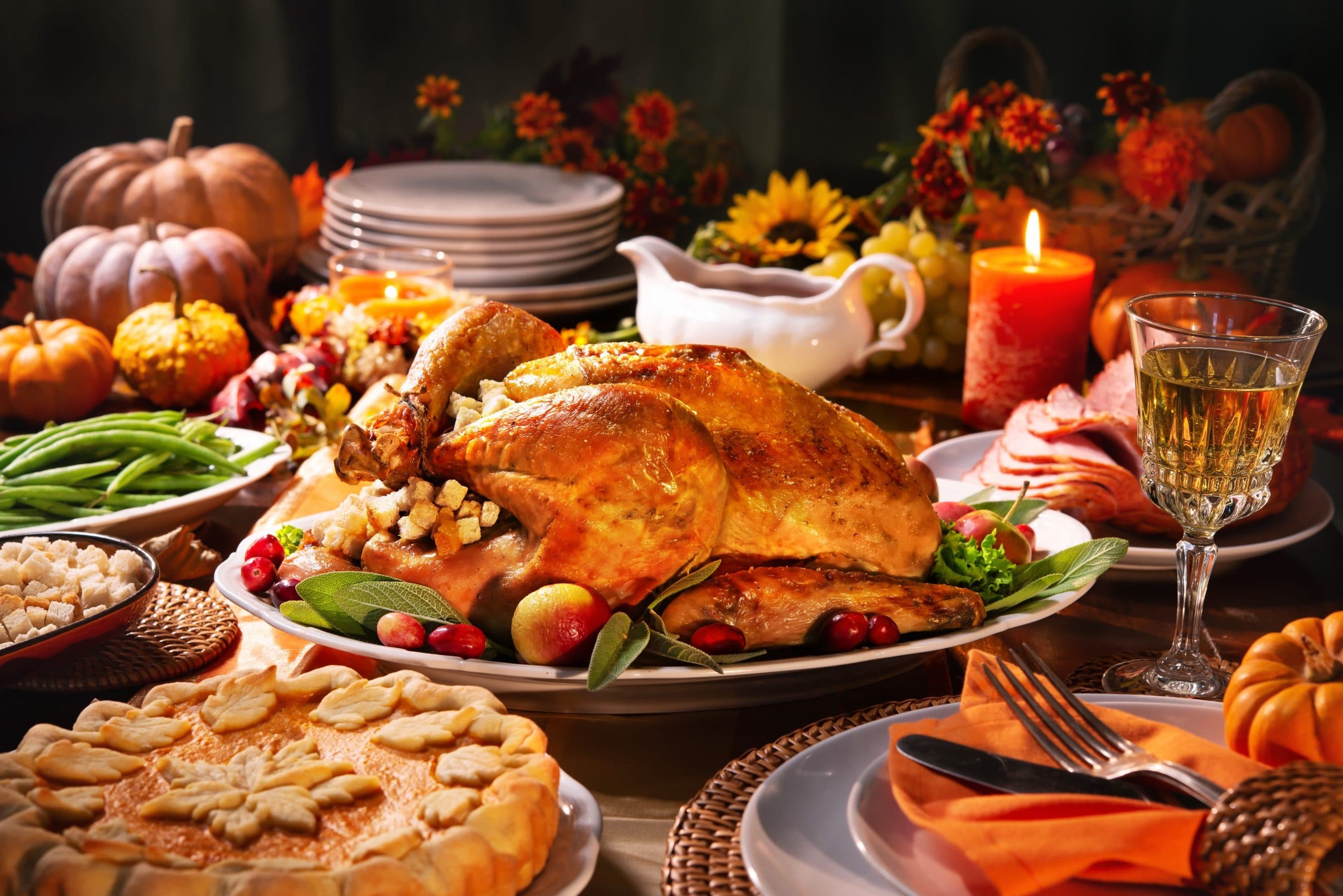 Thanksgiving-style banquet table with roasted turkey and sides