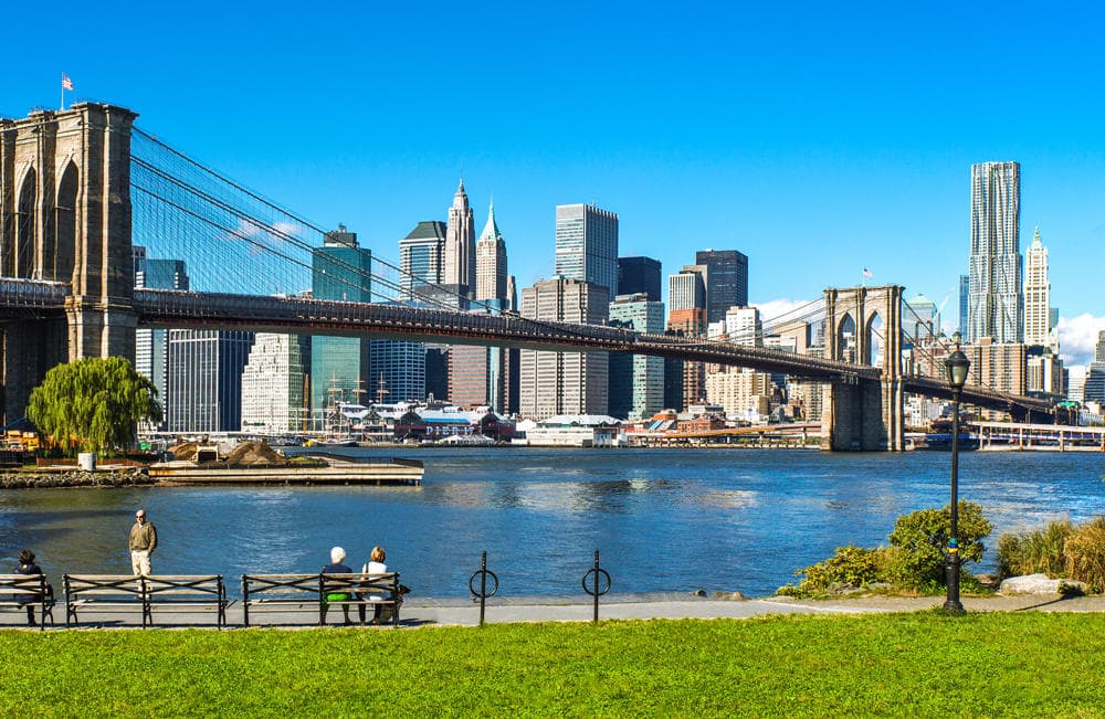Brooklyn Bridge skyline with cyclists riding waterfront tour