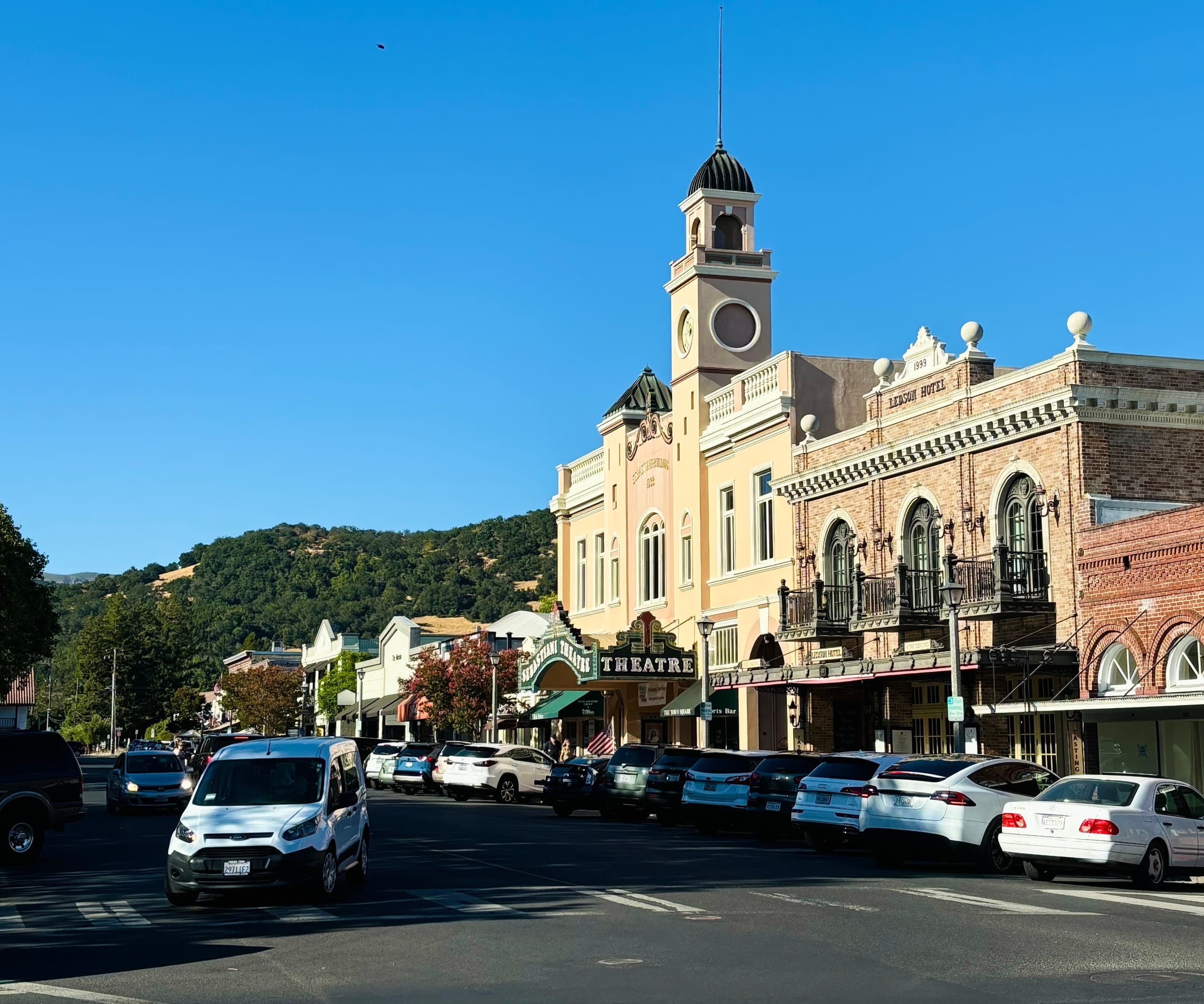 Historic main street with clocktower and mountain backdrop
