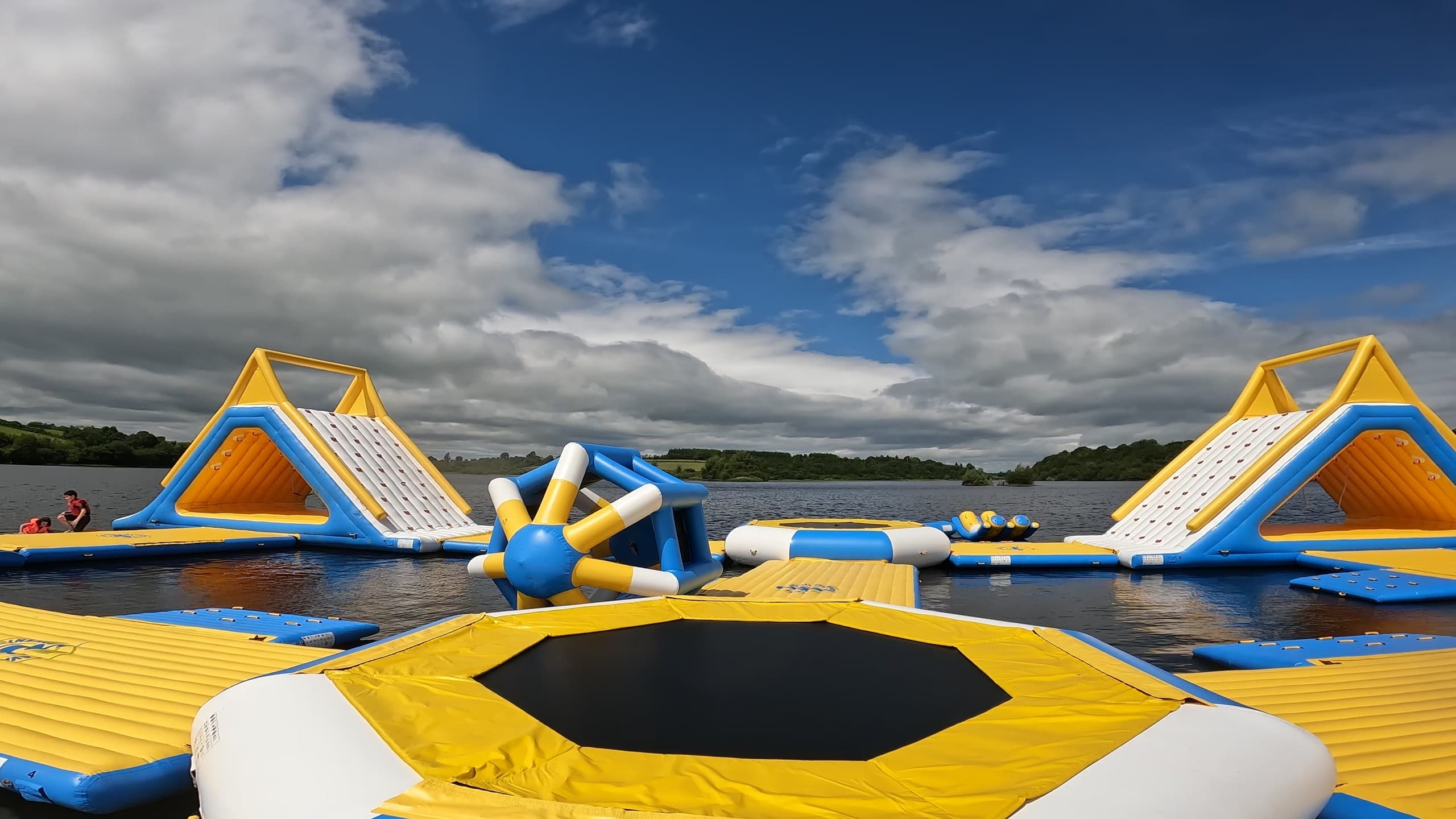 Inflatable waterpark on open lake, adventure aqua obstacle course