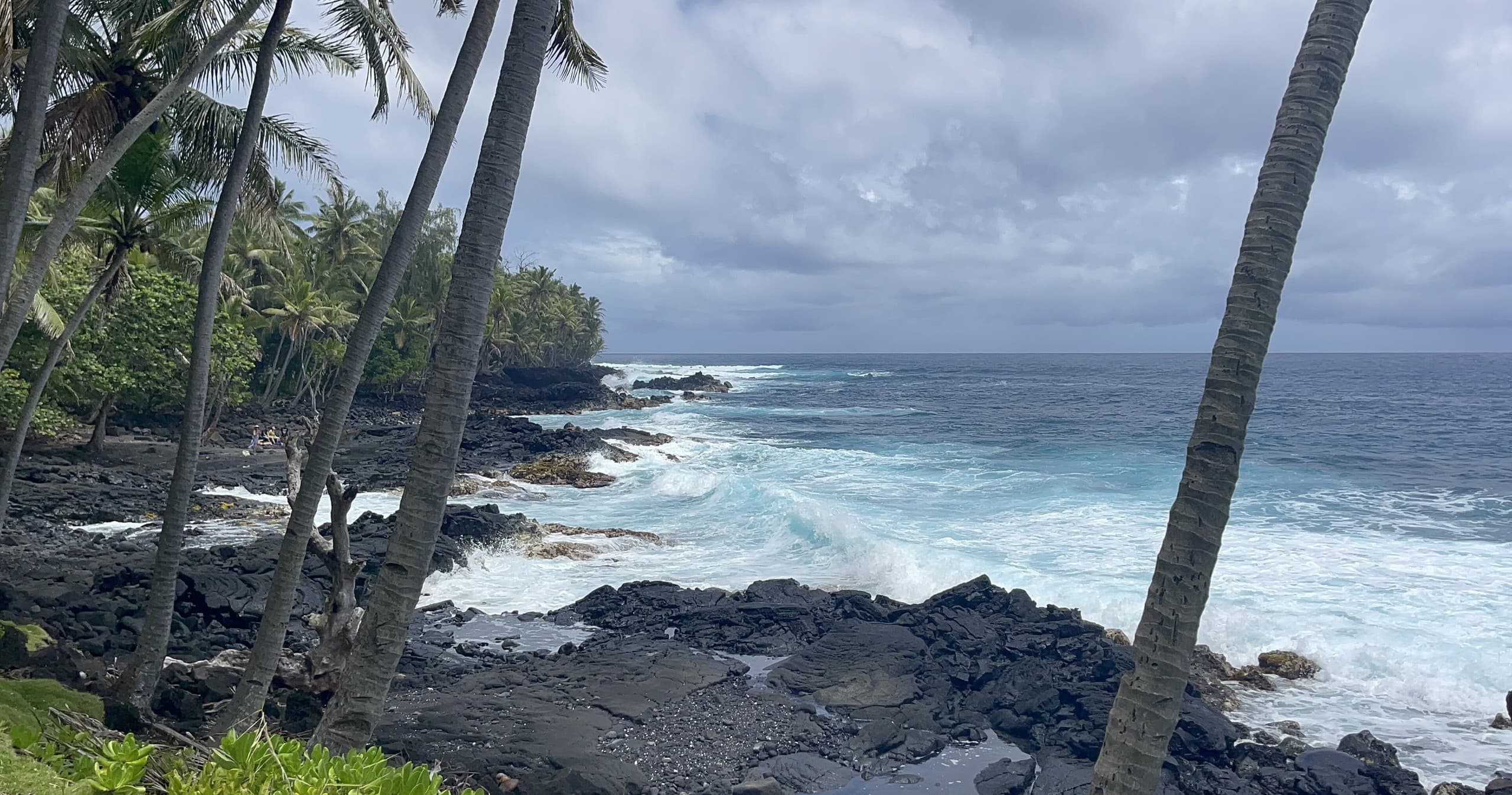 Rugged volcanic coastline with crashing waves on Big Island Hawaii