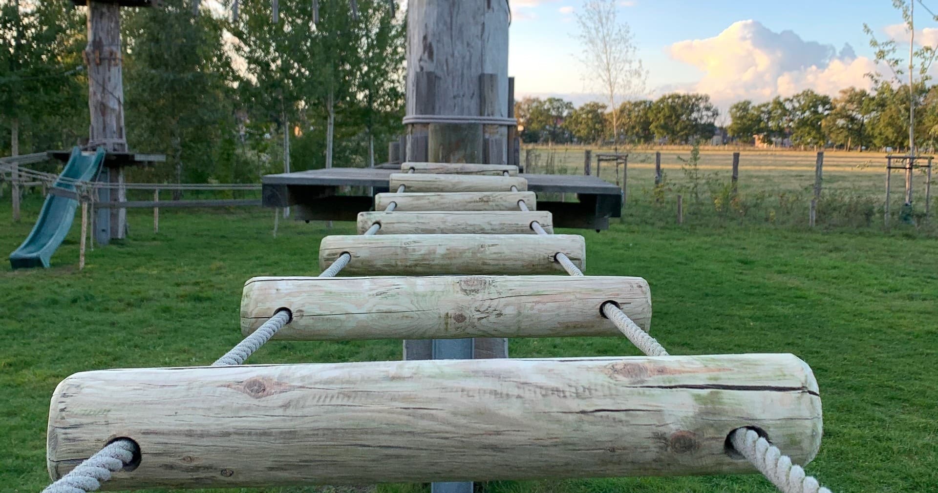 Log ladder on outdoor high ropes course in Norderstedt field