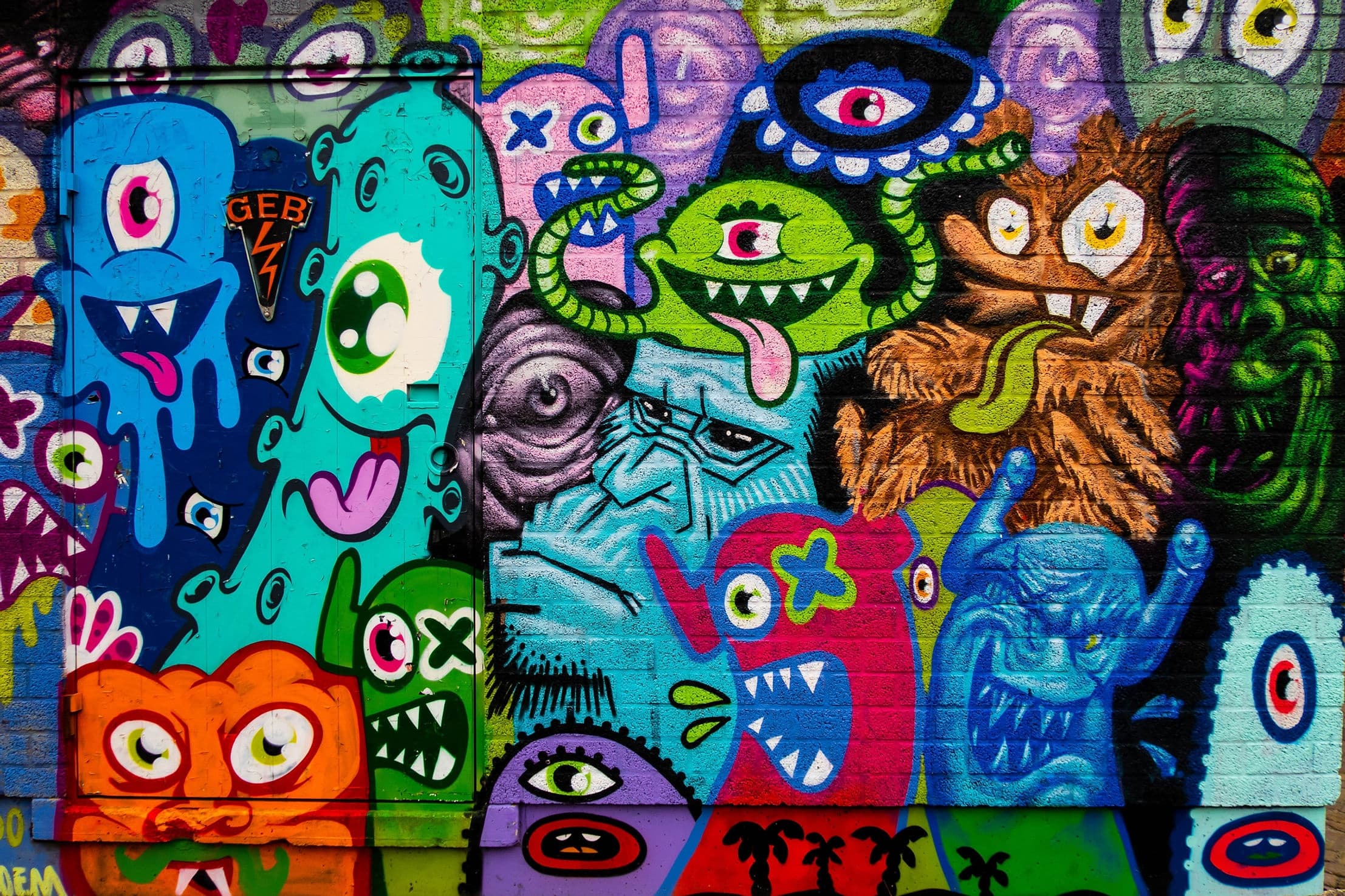 Colorful street graffiti mural on urban wall, vibrant characters