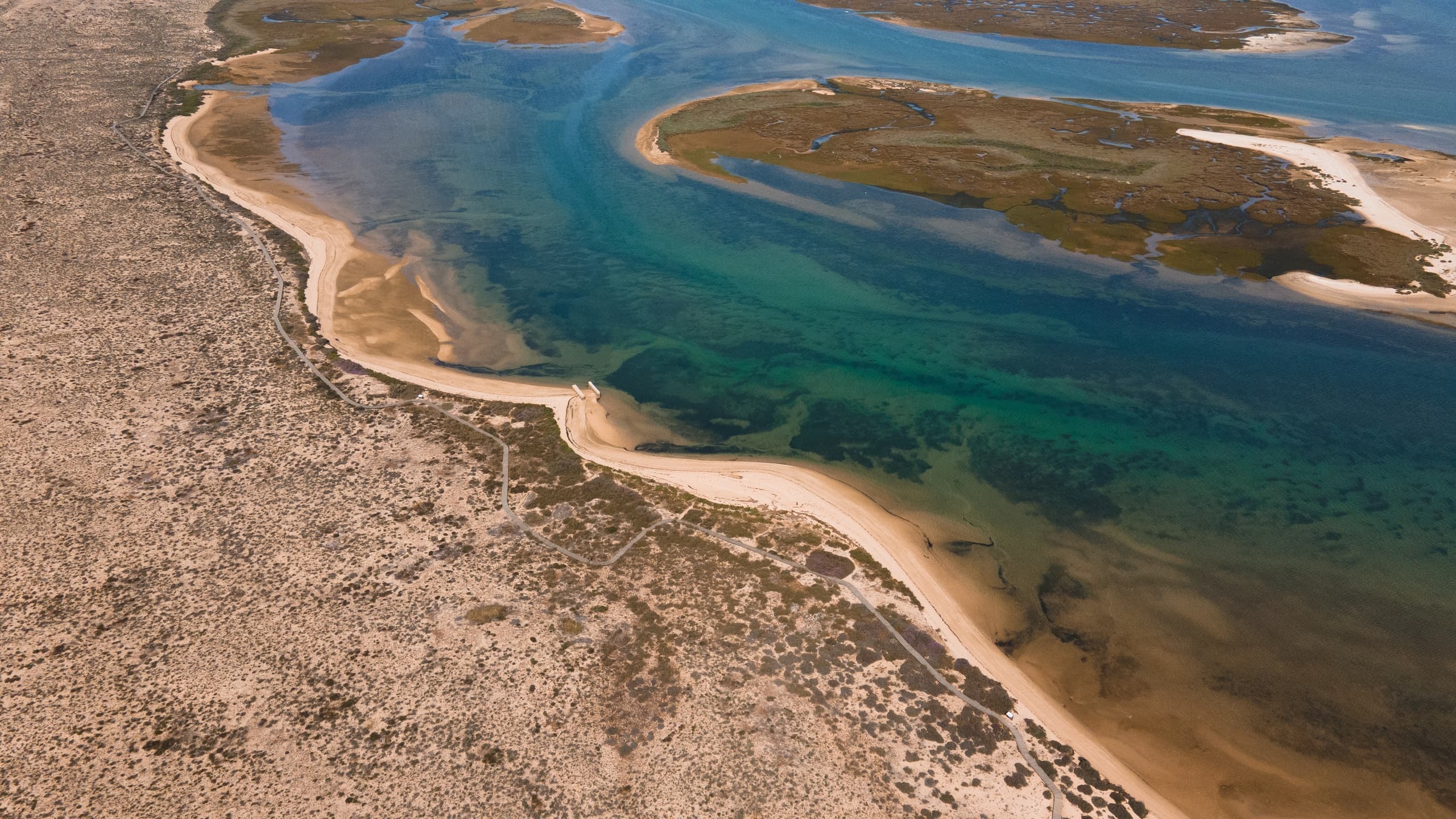 Aerial view of turquoise lagoon and sandbars on Algarve coast