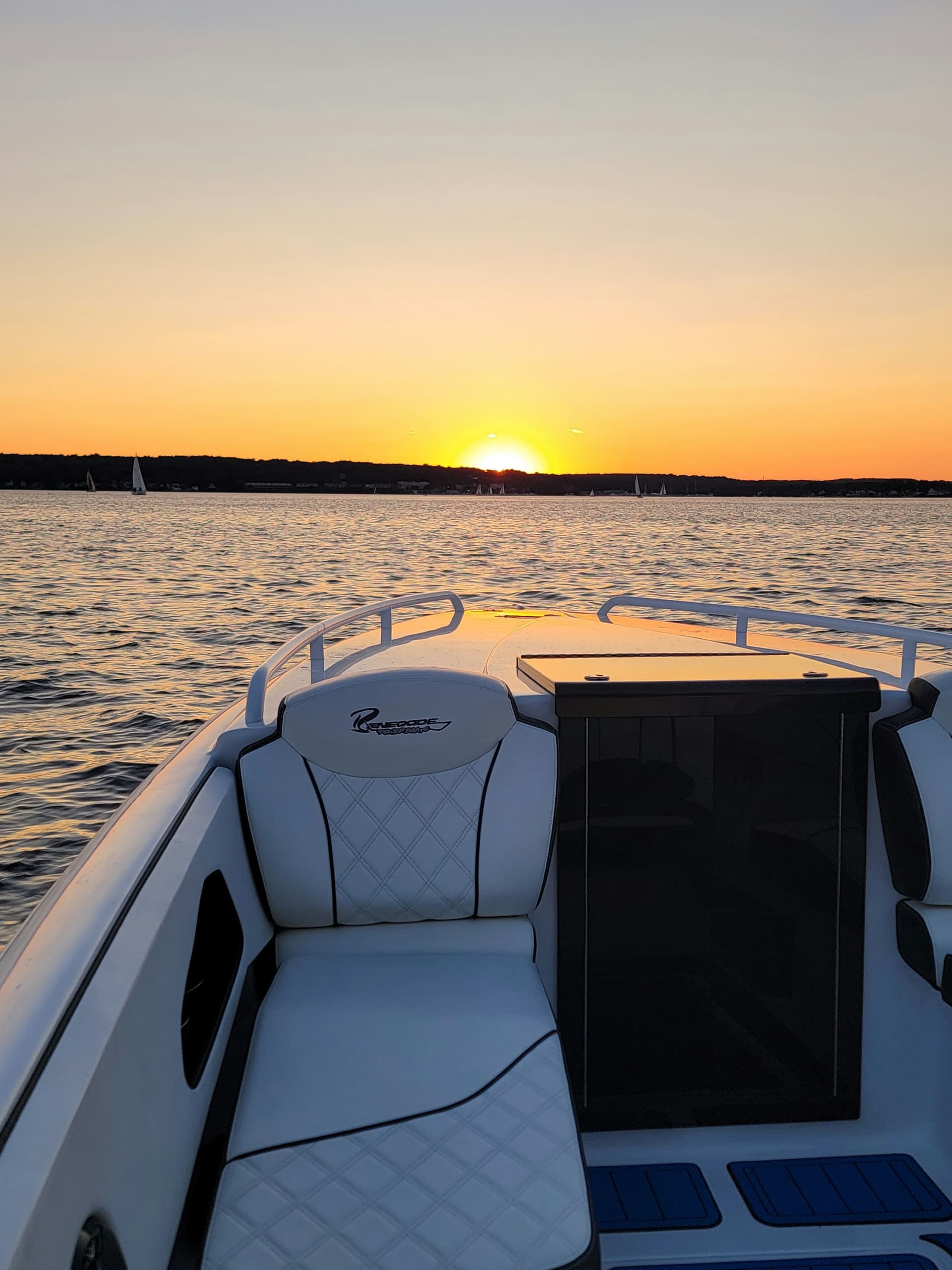 Boat bow seating at sunset on lake, scenic sunset cruise