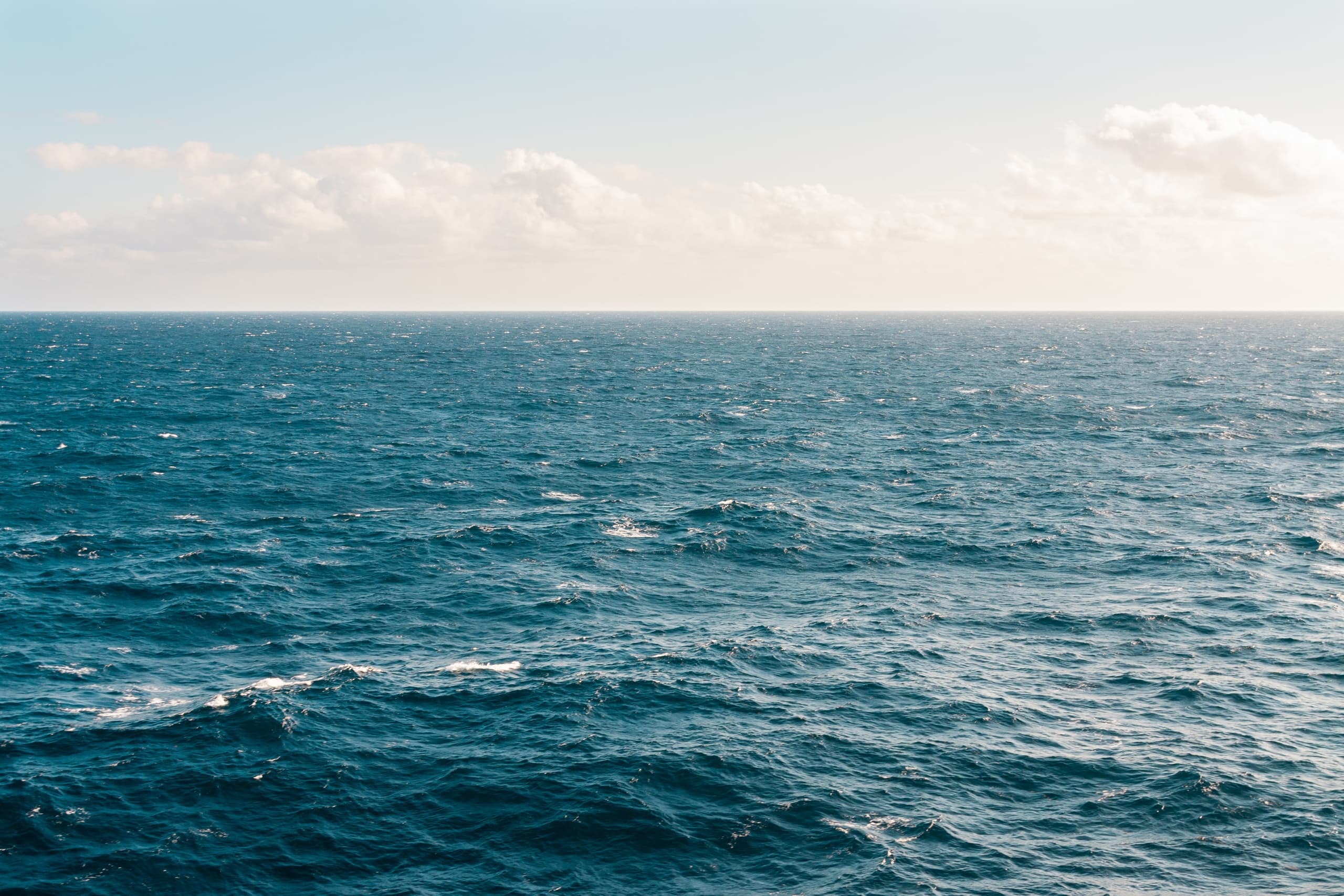 Choppy open sea waves under clear sky ideal for sailing