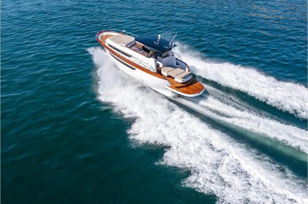 Speedboat carving dynamic wake across turquoise Mediterranean sea