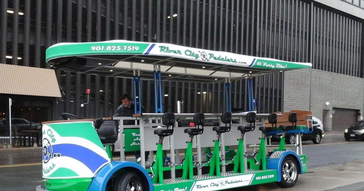 River City Pedalers pedal pub parked on city street, ready for tour