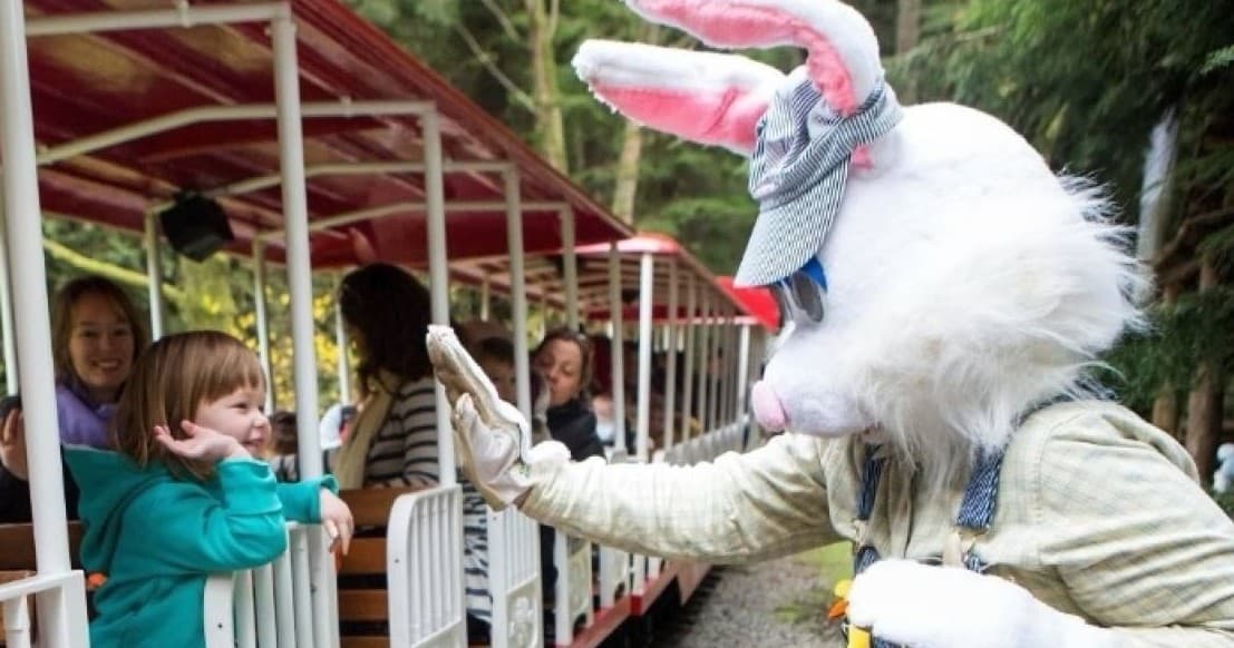 Easter Bunny greeting riders on outdoor park train ride