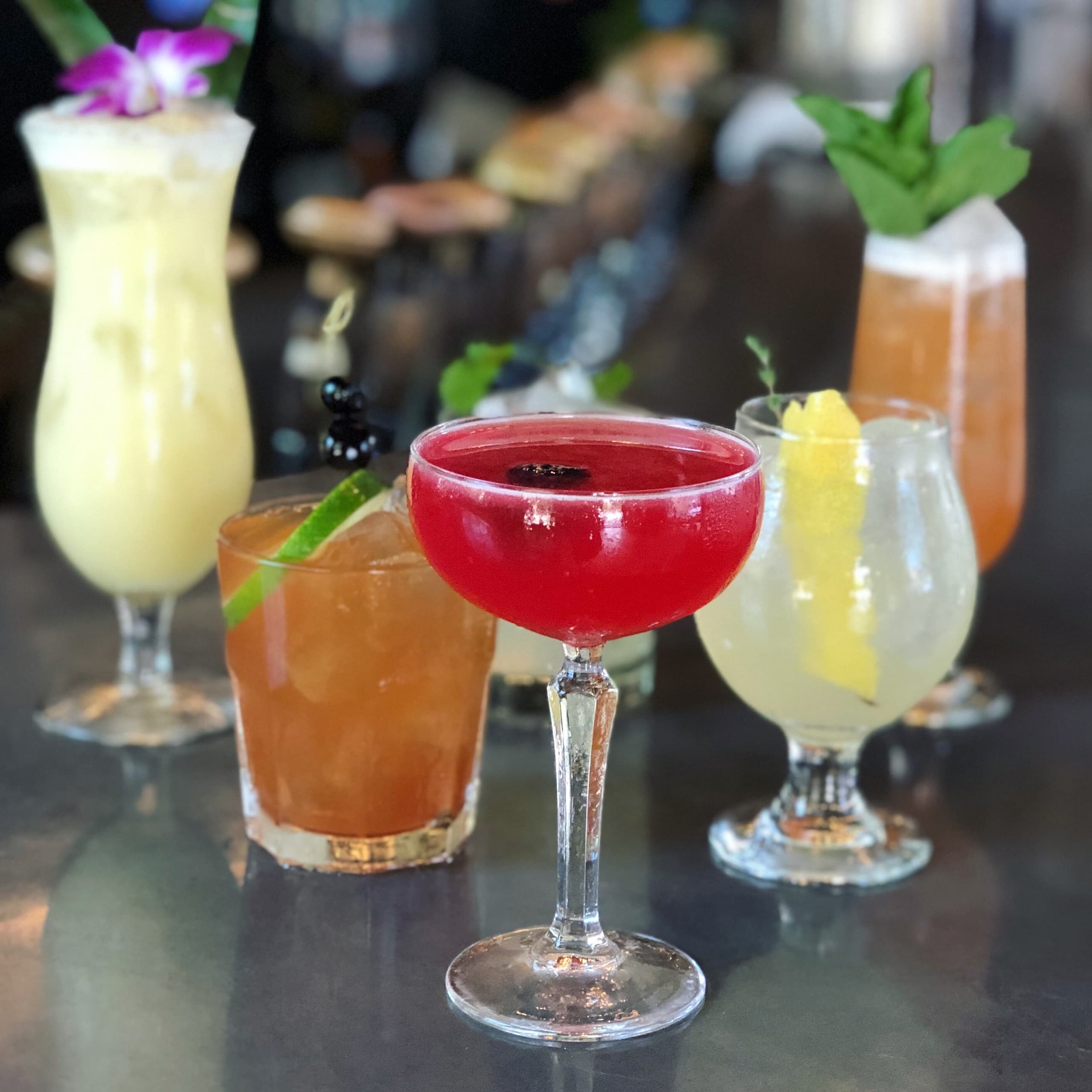 Colorful craft cocktails on bar counter at local restaurant