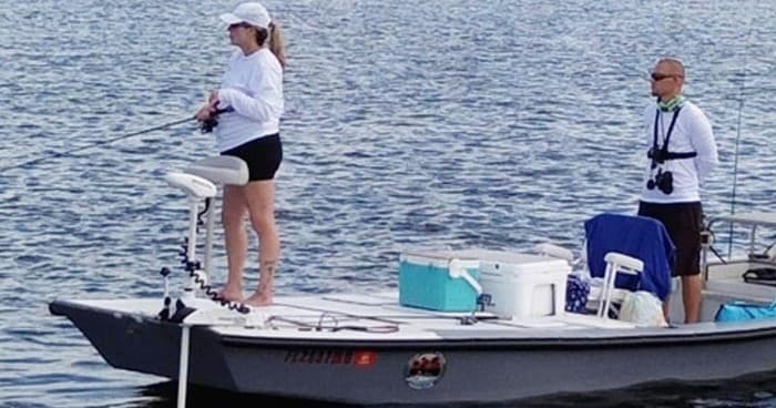Anglers fishing from skiff in calm open water, inshore trip