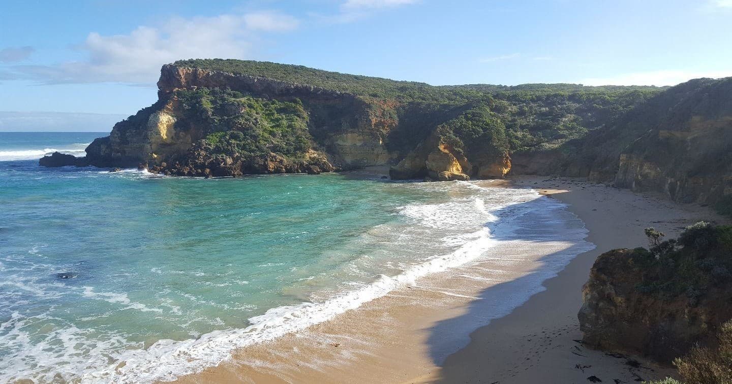 Secluded coastal cove with turquoise surf and sandy beach