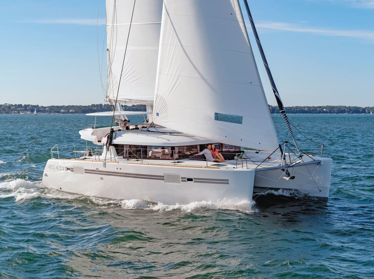 Catamaran sailing in Caribbean waters, passengers cruising offshore