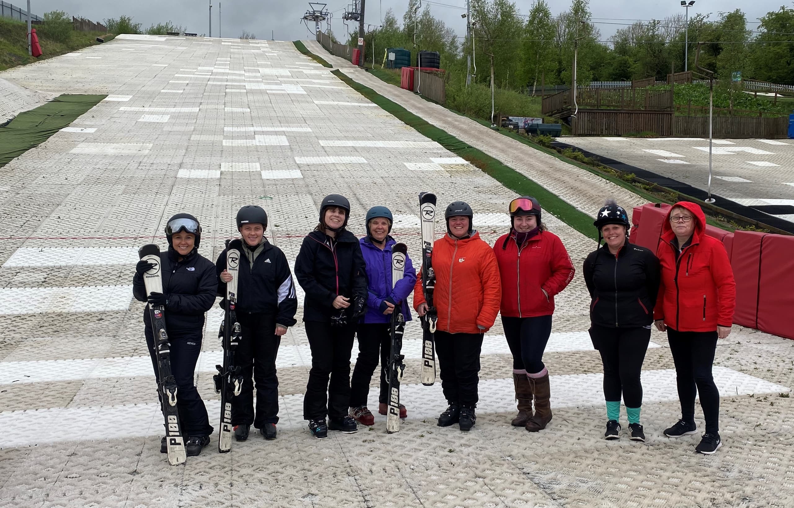 Instructors and learners lined up on dry ski slope practice