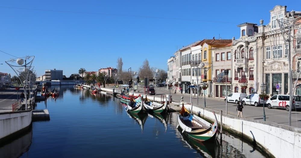 Moliceiro canal boats in Aveiro city canal under blue sky