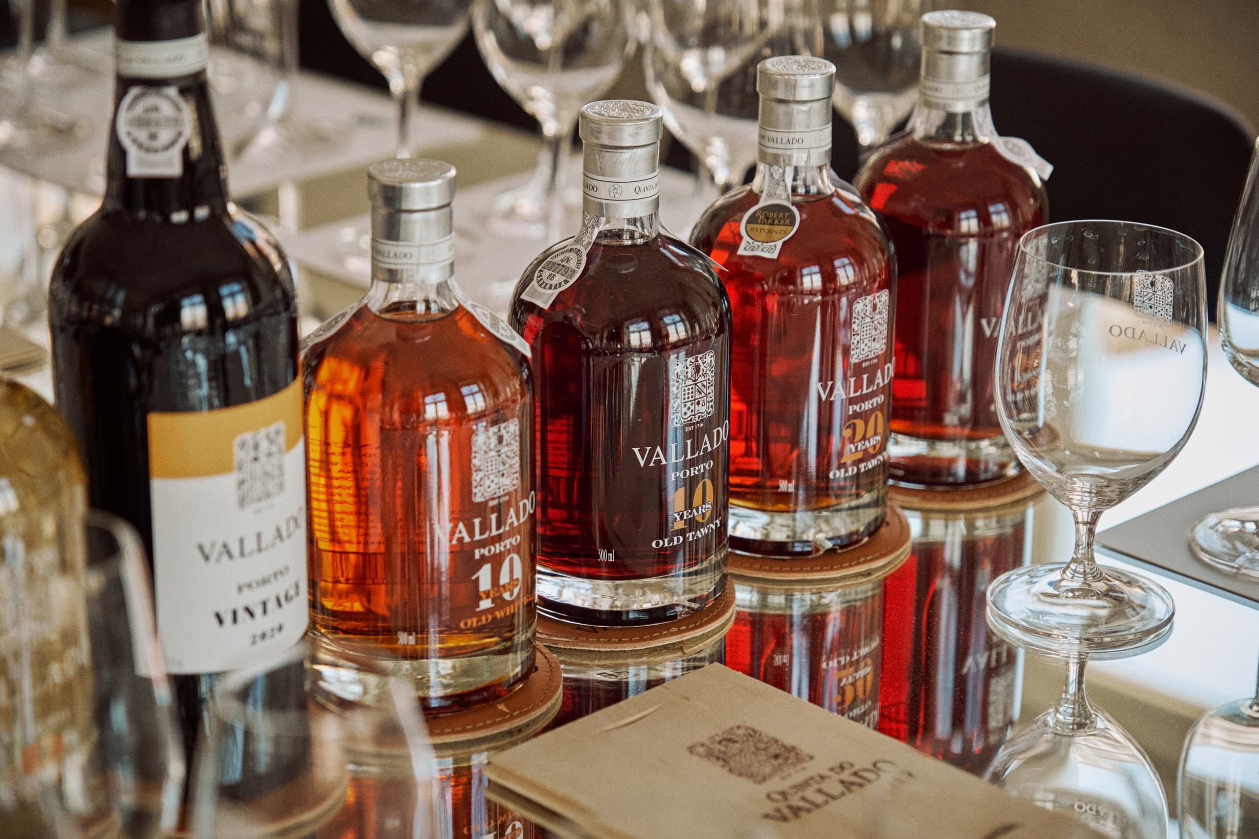Assorted wine bottles and glasses arranged on elegant tasting table