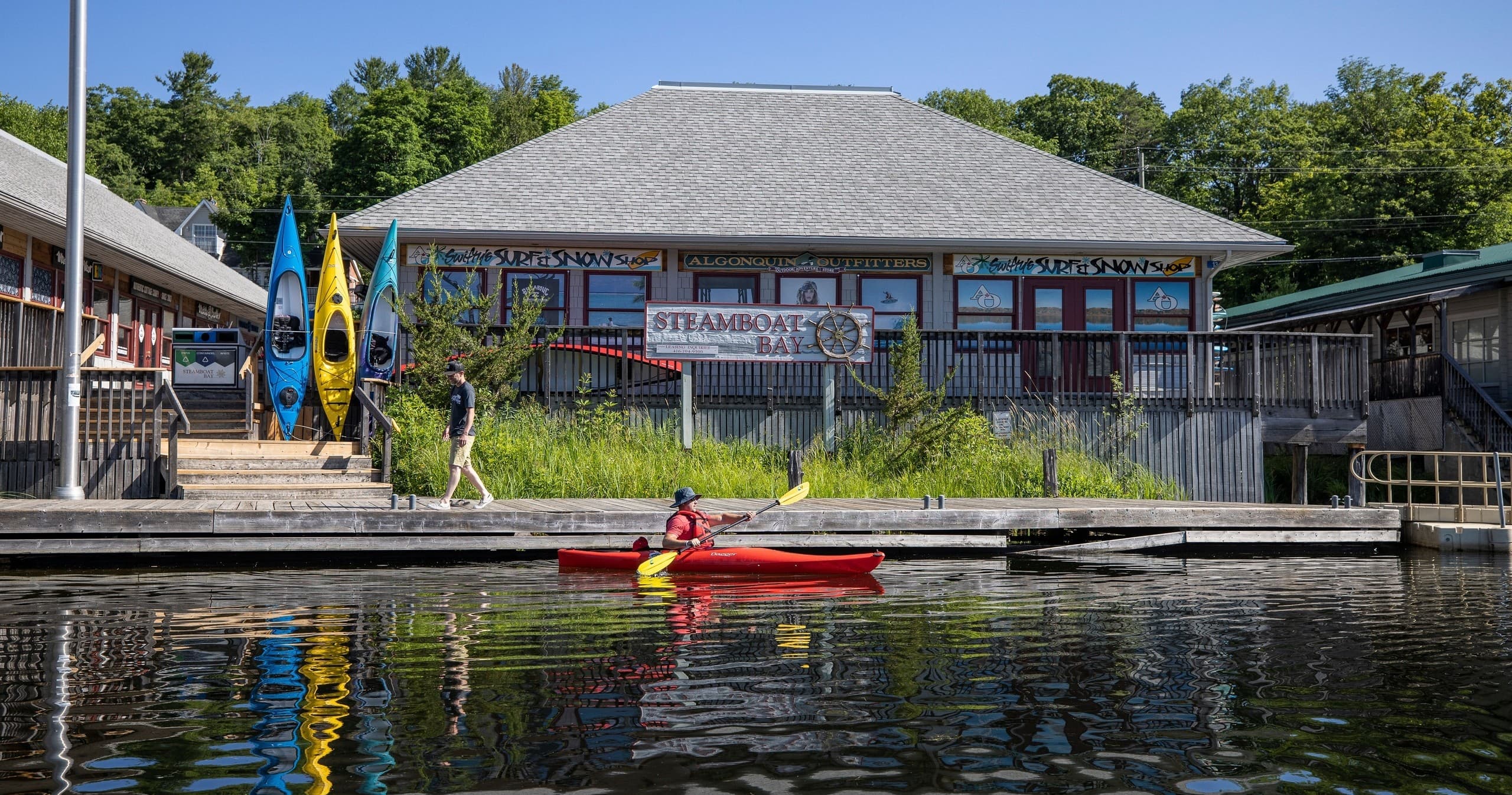 Yellow canoe resting on clear lake shore in Algonquin Park