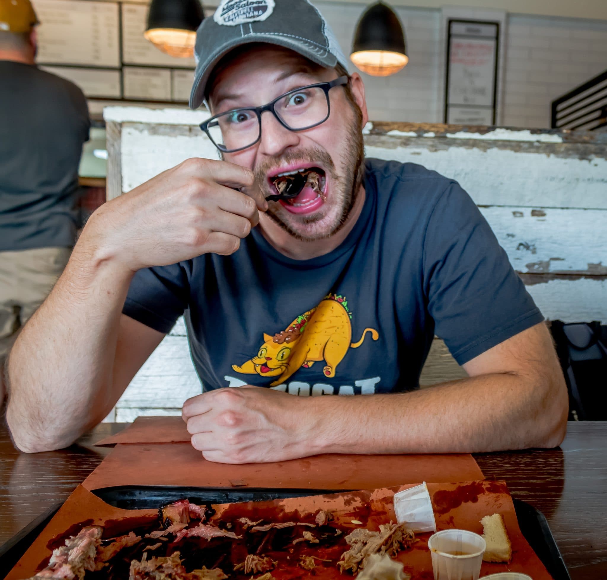 Person enjoying Hungarian barbecue meal at indoor market food tour in Budapest