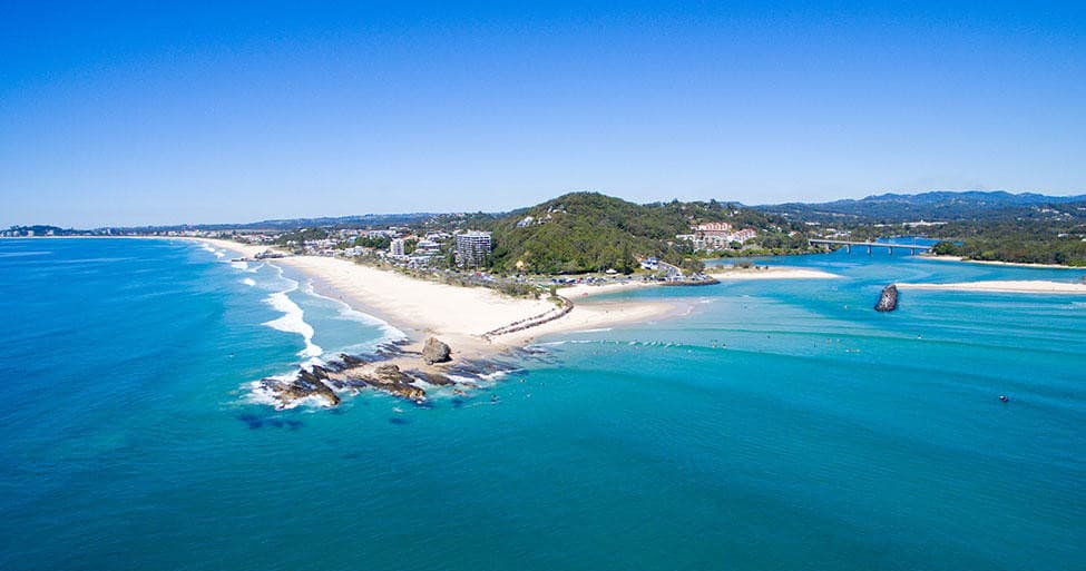 Aerial coastal panorama of sandy beach and turquoise ocean, aerial surf spot