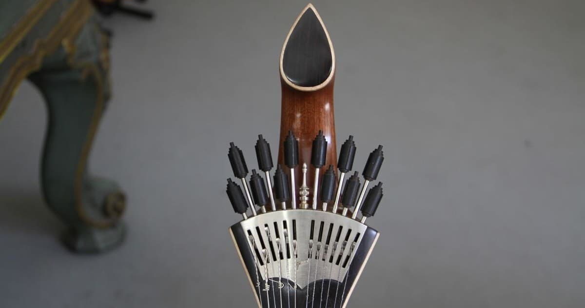 Ornate guitar headstock detail in instrument workshop interior