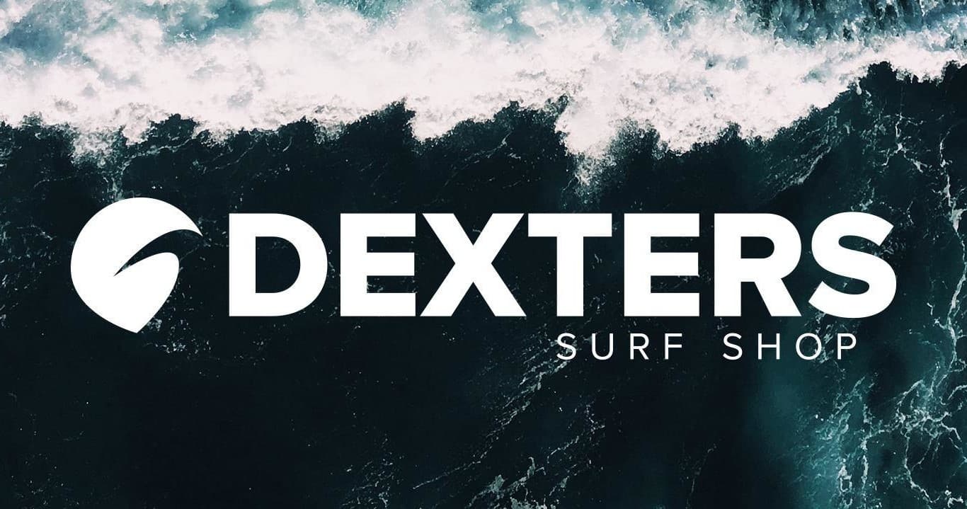 Dexters Surf Shop logo over dramatic ocean wave backdrop